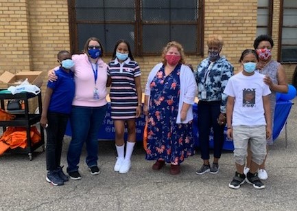 teachers standing with their students